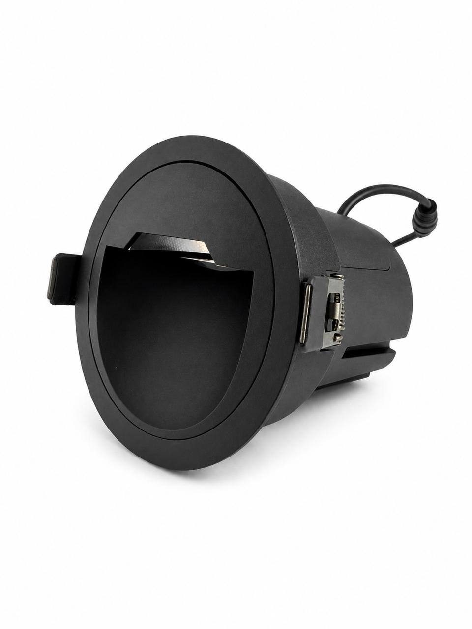 UNIFO from three-quarters: the trim ring, the deep matt-black cowl and the driver body behind it.